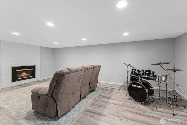13524 E 5th Ave, Spokane Valley, WA 99216 - cinema room featuring wood finished floors, baseboards, a brick fireplace, and recessed lighting