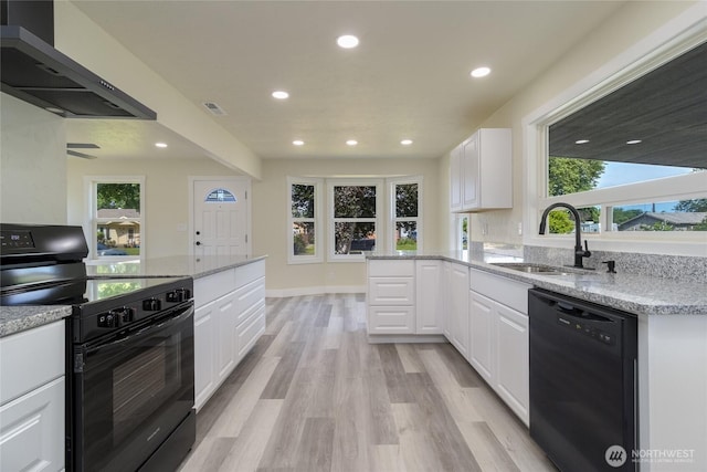 605 Holly St, Walla Walla, WA 99362 - kitchen featuring black appliances, wall chimney range hood, a sink, white cabinets, and recessed lighting