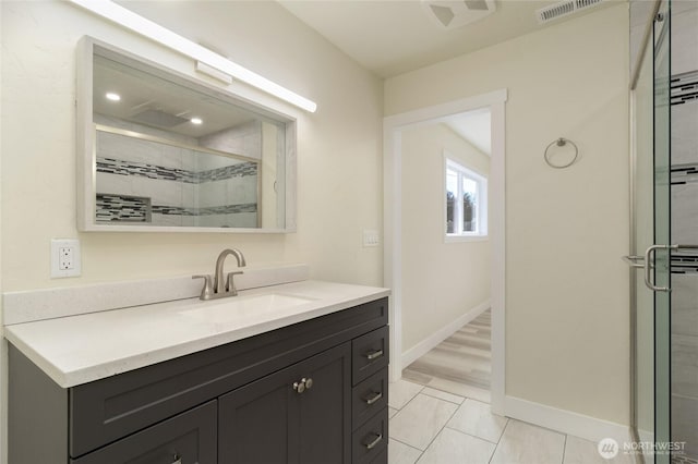 605 Holly St, Walla Walla, WA 99362 - bathroom with a stall shower, vanity, baseboards, and tile patterned flooring