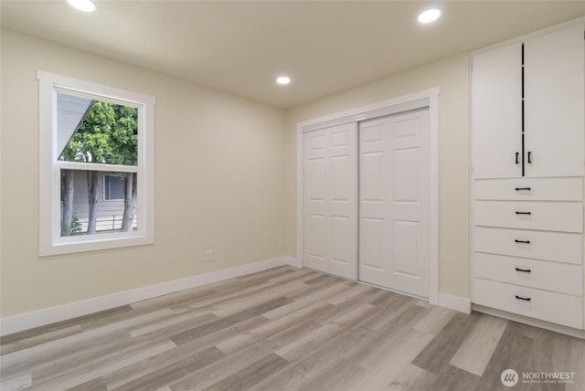 605 Holly St, Walla Walla, WA 99362 - unfurnished bedroom with light wood-type flooring, recessed lighting, baseboards, and a closet