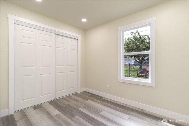 605 Holly St, Walla Walla, WA 99362 - unfurnished bedroom with multiple windows, wood finished floors, recessed lighting, baseboards, and a closet