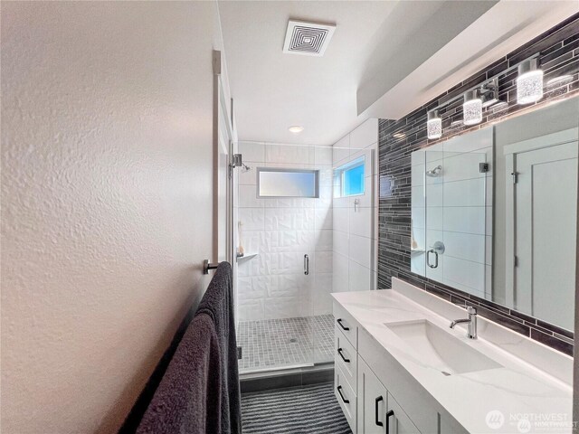 1042 S Donovan St Unit 5, Seattle, WA 98108 - full bath with vanity, a stall shower, and a textured wall