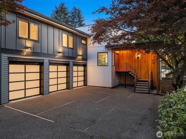 747 14th Ave W, Kirkland, WA 98033 - view of front of house with an attached garage and board and batten siding