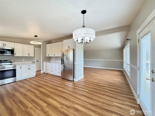 1538 W 12th St, Port Angeles, WA 98363 - kitchen with stainless steel appliances, light countertops, light wood-style flooring, and white cabinets