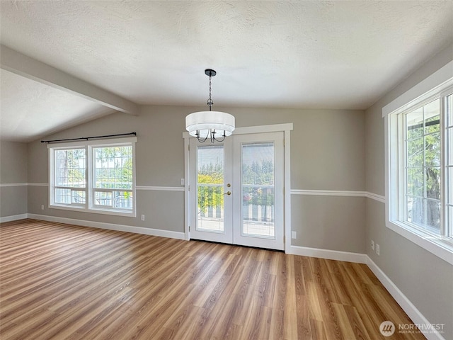 1538 W 12th St, Port Angeles, WA 98363 - unfurnished dining area featuring plenty of natural light, a chandelier, light wood finished floors, baseboards, and a textured ceiling
