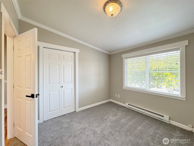 1538 W 12th St, Port Angeles, WA 98363 - unfurnished bedroom with baseboard heating, crown molding, carpet flooring, baseboards, and a closet
