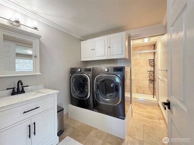 1538 W 12th St, Port Angeles, WA 98363 - laundry room with washer and dryer, cabinet space, ornamental molding, and a textured ceiling