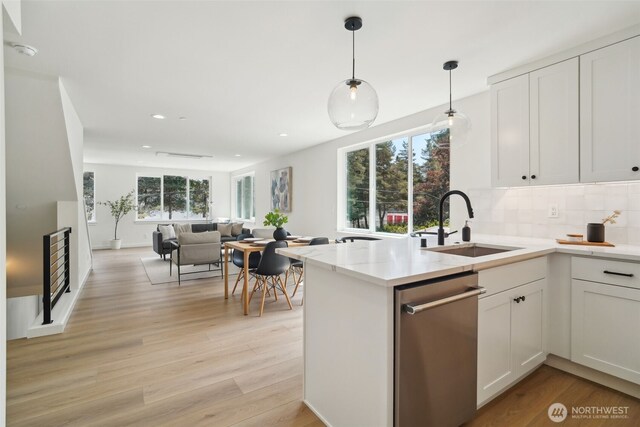 20315 14th Ave NE Unit A & B, Shoreline, WA 98155 - kitchen featuring stainless steel dishwasher, a peninsula, white cabinetry, a sink, and recessed lighting