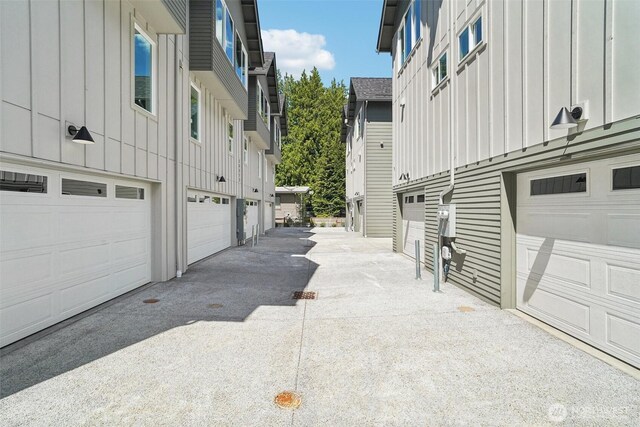 20315 14th Ave NE Unit A & B, Shoreline, WA 98155 - view of property exterior with board and batten siding, driveway, and a garage