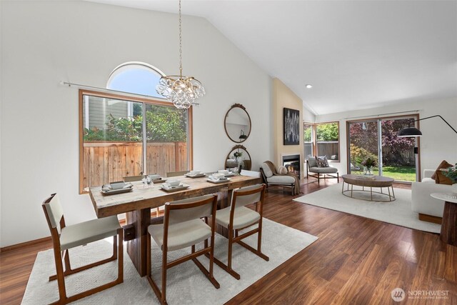 12731 102nd Ave NE, Kirkland, WA 98034 - dining room with a glass covered fireplace, dark wood finished floors, a chandelier, and high vaulted ceiling