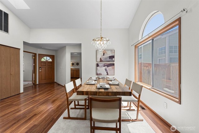 12731 102nd Ave NE, Kirkland, WA 98034 - dining area featuring wood finished floors, a chandelier, and a skylight