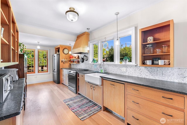 2218 Williams St, Bellingham, WA 98225 - kitchen with open shelves, stainless steel appliances, custom range hood, a sink, and decorative backsplash