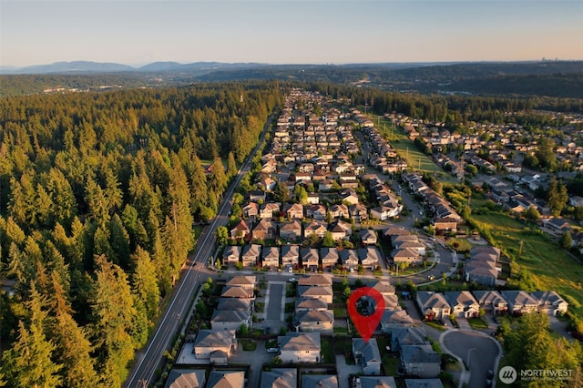 4408 214th Pl SE, Bothell, WA 98021 - aerial view of property and surrounding area featuring nearby suburban area, a forest, and mountains
