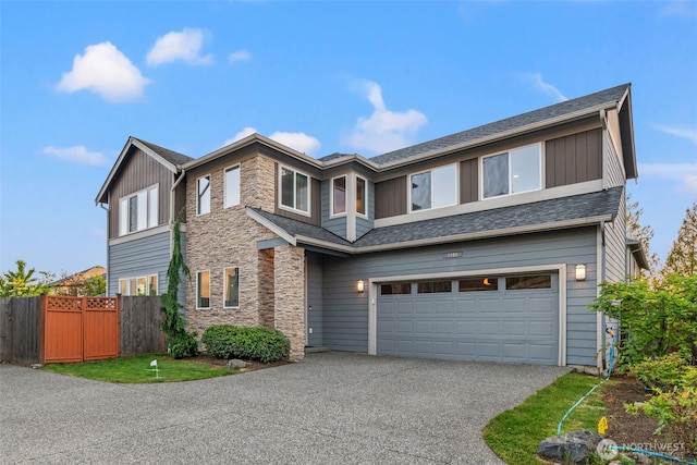 4408 214th Pl SE, Bothell, WA 98021 - view of front of property with an attached garage, stone siding, asphalt driveway, and board and batten siding