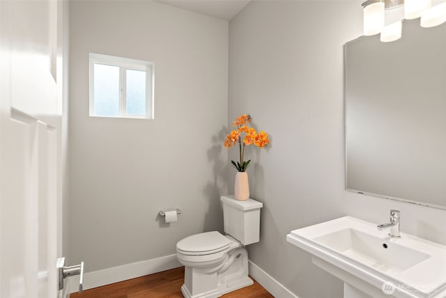 4408 214th Pl SE, Bothell, WA 98021 - bathroom with a sink, toilet, wood finished floors, and baseboards