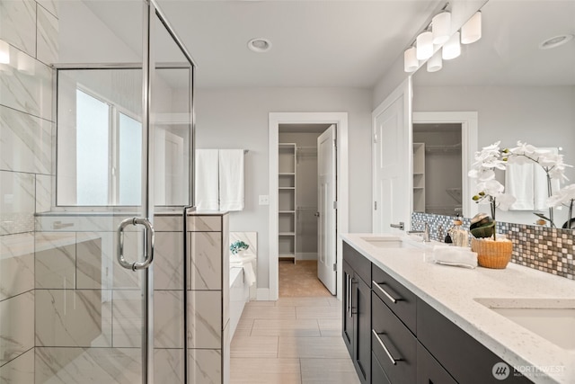 4408 214th Pl SE, Bothell, WA 98021 - full bathroom with double vanity, a garden tub, a spacious closet, a shower stall, and backsplash