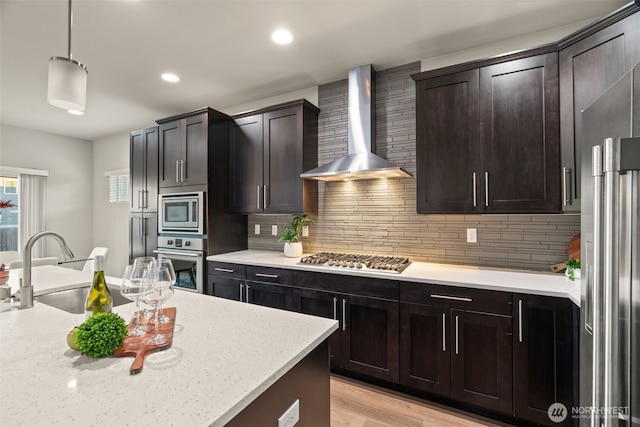 4408 214th Pl SE, Bothell, WA 98021 - kitchen featuring wall chimney exhaust hood, stainless steel appliances, backsplash, a sink, and hanging light fixtures