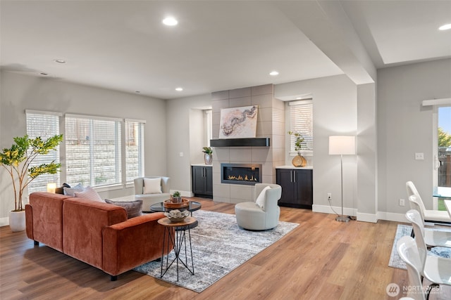 4408 214th Pl SE, Bothell, WA 98021 - living room featuring light wood-style floors, baseboards, plenty of natural light, recessed lighting, and a fireplace