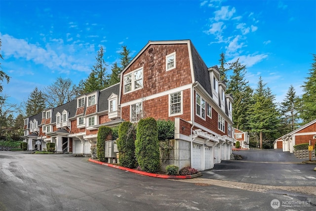 3046 128th Ave SE Unit 30, Bellevue, WA 98005 - view of building exterior featuring a garage, driveway, and a residential view