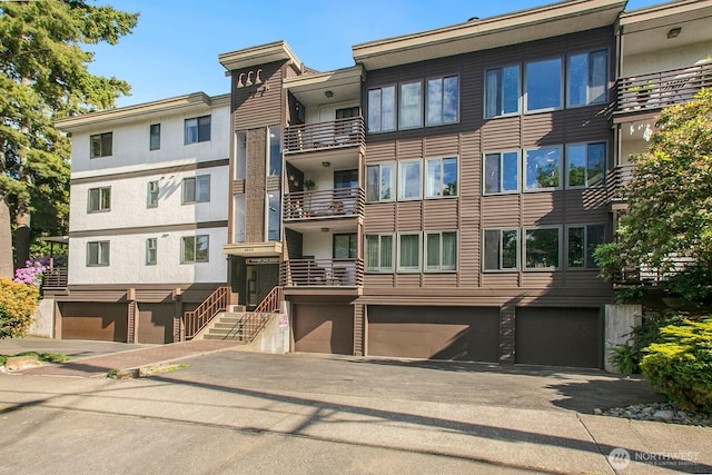 3505 W Government Way Unit 203, Seattle, WA 98199 - view of property with an attached garage and driveway