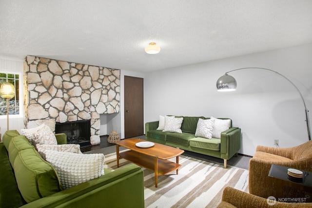 3505 W Government Way Unit 203, Seattle, WA 98199 - living room with a stone fireplace and a textured ceiling