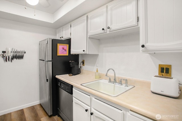 3505 W Government Way Unit 203, Seattle, WA 98199 - kitchen featuring dishwasher, a sink, white cabinetry, dark wood finished floors, and light countertops