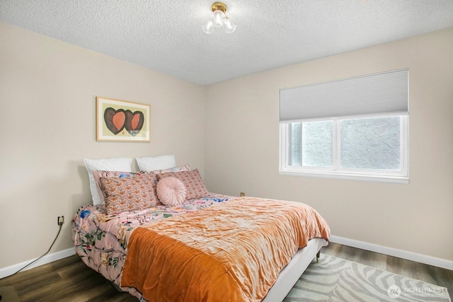 3505 W Government Way Unit 203, Seattle, WA 98199 - bedroom featuring baseboards, wood finished floors, and a textured ceiling