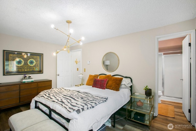 3505 W Government Way Unit 203, Seattle, WA 98199 - bedroom with wood finished floors, a textured ceiling, and a chandelier