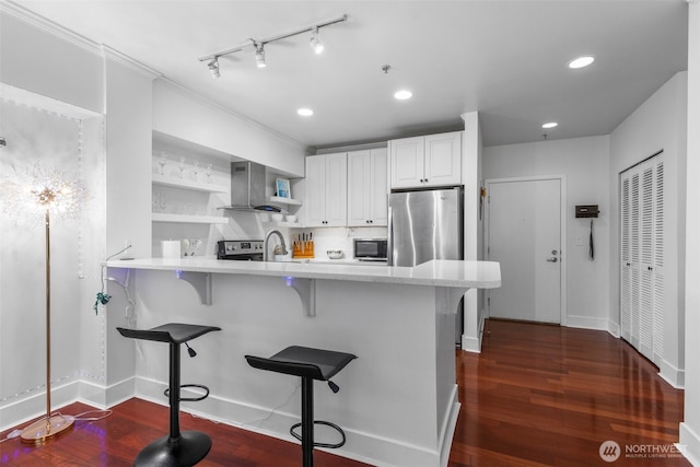 19500 Ballinger Way NE Unit 109, Shoreline, WA 98155 - kitchen featuring appliances with stainless steel finishes, light countertops, open shelves, a peninsula, and a breakfast bar
