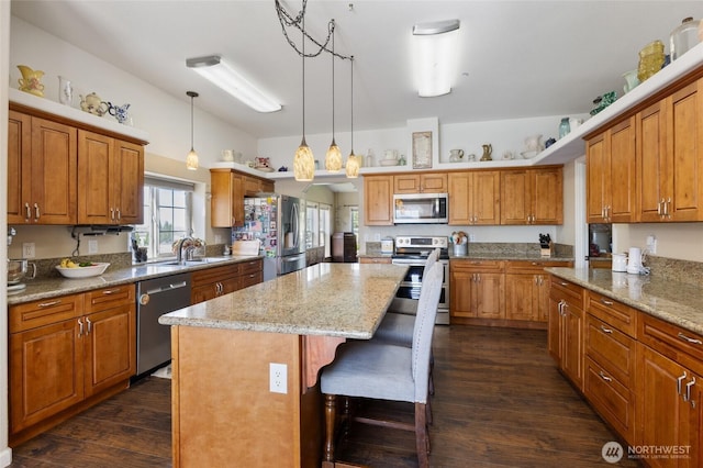 1183 E.9 Rd NE, Moses Lake, WA 98837 - kitchen with stainless steel appliances, a center island, a sink, dark wood finished floors, and brown cabinetry