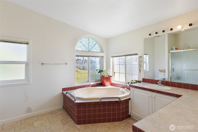 1183 E.9 Rd NE, Moses Lake, WA 98837 - bathroom featuring vanity, a garden tub, a stall shower, and baseboards