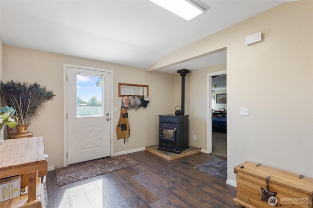 1183 E.9 Rd NE, Moses Lake, WA 98837 - foyer entrance featuring a wood stove, dark wood-style flooring, baseboards, and lofted ceiling
