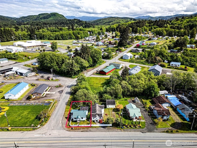 16672 Frontier St, Clallam Bay, WA 98326 - aerial view of property's location featuring property parcel outlined, mountains, and a heavily wooded area