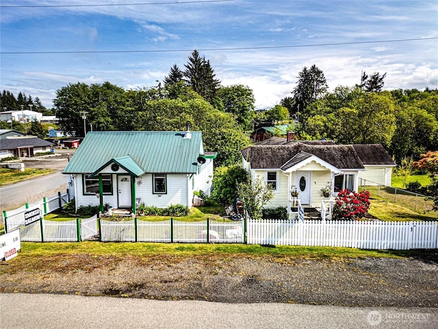 16672 Frontier St, Clallam Bay, WA 98326 - view of front facade featuring metal roof and a fenced front yard