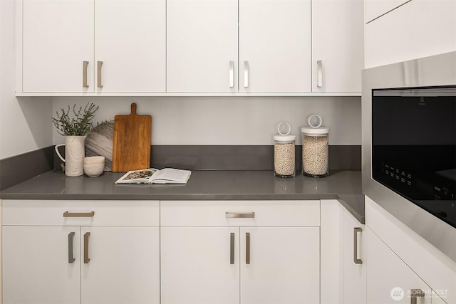 5822 56th Ave NE, Seattle, WA 98105 - kitchen view of white cabinetry and dark countertops