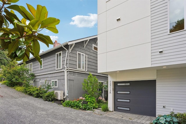 13713 35th Ave NE Unit A, Seattle, WA 98125 - view of side of property with an attached garage and an ac unit