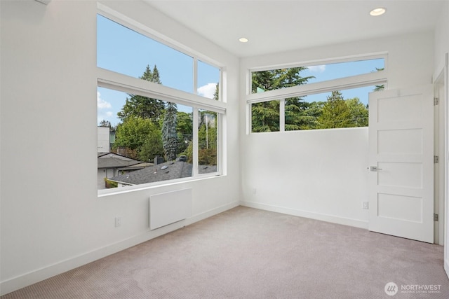 13713 35th Ave NE Unit A, Seattle, WA 98125 - carpeted empty room with plenty of natural light, radiator heating unit, and recessed lighting