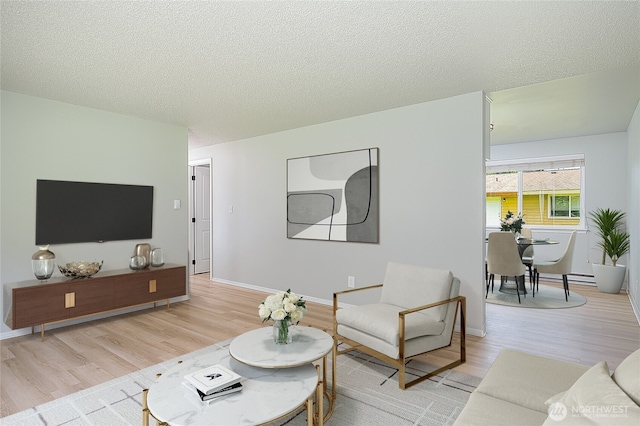 12672 179th Ave SE, Monroe, WA 98272 - living area with light wood-style flooring, a textured ceiling, and baseboards