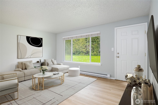 12672 179th Ave SE, Monroe, WA 98272 - living area with a baseboard heating unit, wood finished floors, and a textured ceiling