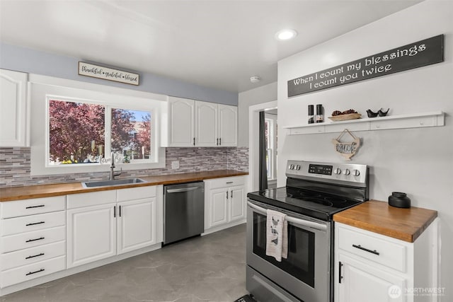 121 SW Alfred Ave, Chehalis, WA 98532 - kitchen with appliances with stainless steel finishes, butcher block counters, a sink, decorative backsplash, and recessed lighting