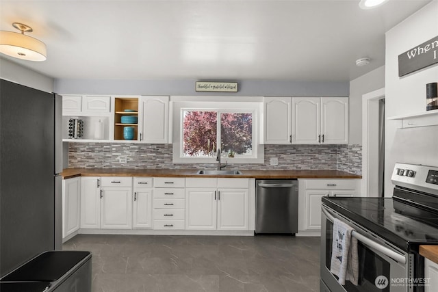121 SW Alfred Ave, Chehalis, WA 98532 - kitchen featuring appliances with stainless steel finishes, butcher block countertops, a sink, and tasteful backsplash
