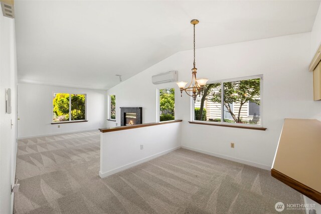 24831 110th Pl SE Unit 51D, Kent, WA 98030 - unfurnished living room featuring a wall mounted AC, a chandelier, light colored carpet, vaulted ceiling, and plenty of natural light