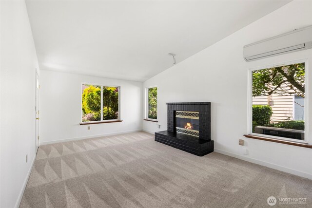 24831 110th Pl SE Unit 51D, Kent, WA 98030 - unfurnished living room featuring a wall mounted AC, carpet, baseboards, and vaulted ceiling