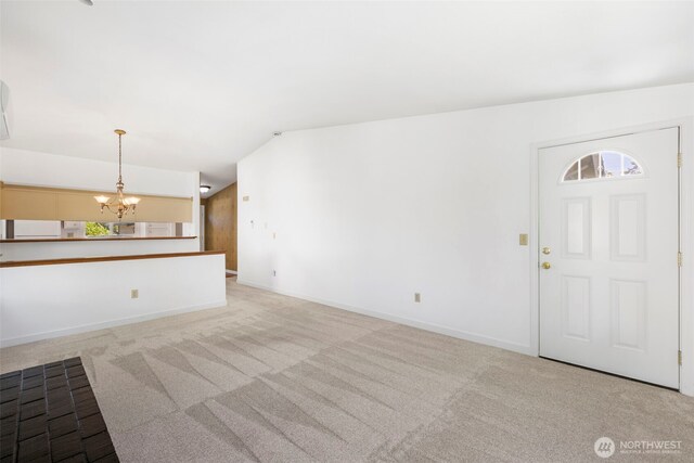 24831 110th Pl SE Unit 51D, Kent, WA 98030 - unfurnished living room featuring a chandelier, carpet flooring, baseboards, and vaulted ceiling