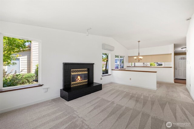 24831 110th Pl SE Unit 51D, Kent, WA 98030 - unfurnished living room featuring vaulted ceiling, a chandelier, light colored carpet, a brick fireplace, and a wall unit AC