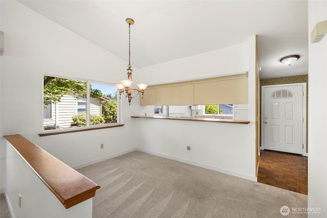 24831 110th Pl SE Unit 51D, Kent, WA 98030 - unfurnished dining area with baseboards, a chandelier, high vaulted ceiling, and carpet flooring