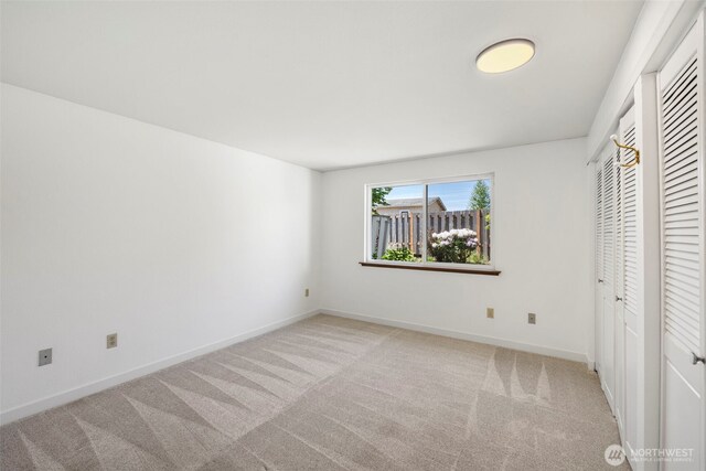 24831 110th Pl SE Unit 51D, Kent, WA 98030 - unfurnished bedroom with carpet, baseboards, and multiple closets