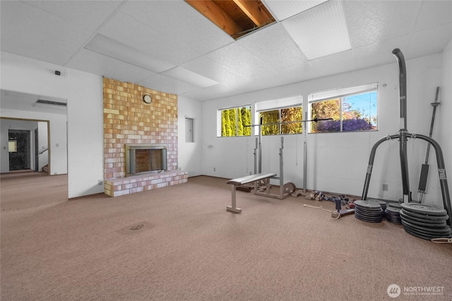 7407 25th Ave NE, Seattle, WA 98115 - exercise area featuring a paneled ceiling, carpet, and a fireplace