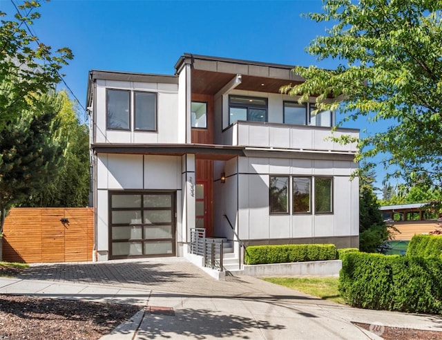 2222 E Mcgraw St, Seattle, WA 98112 - contemporary home featuring a balcony, driveway, and an attached garage