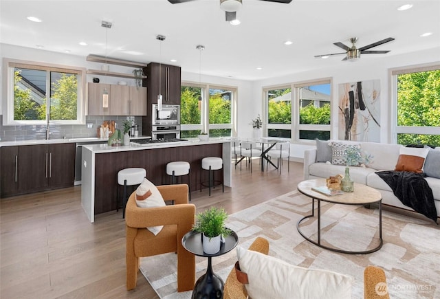 2222 E Mcgraw St, Seattle, WA 98112 - living room with ceiling fan, light wood-style flooring, and recessed lighting